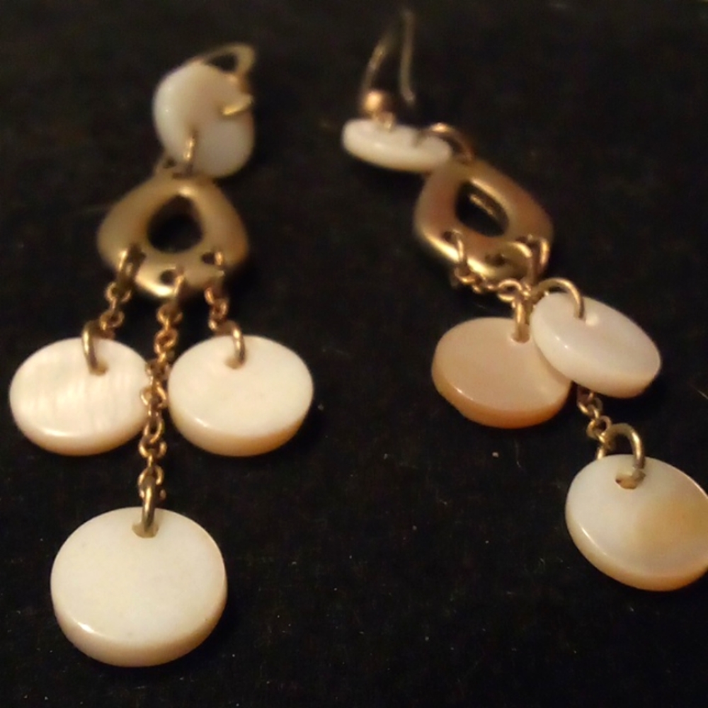 Dangling gold earrings with white discs